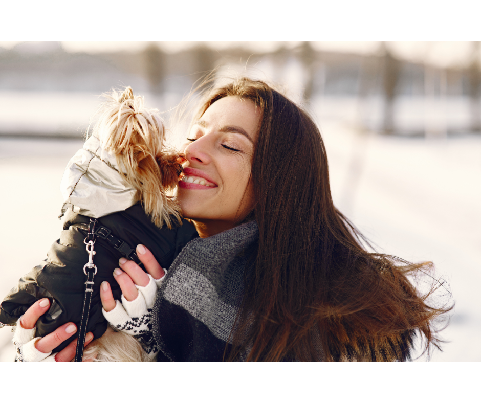 happy woman kissing dog